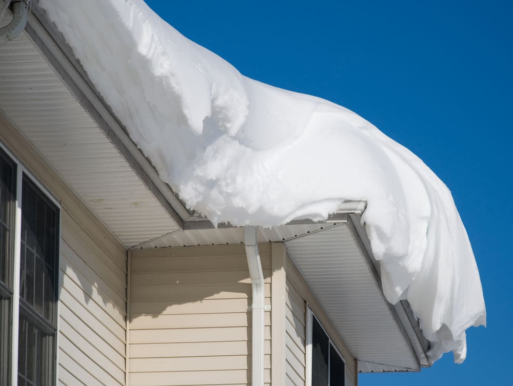 excessive amount of snow piled up on residential roof